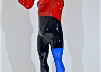 A colorful sculpture featuring red, blue, and black elements, prominently displaying a horn.